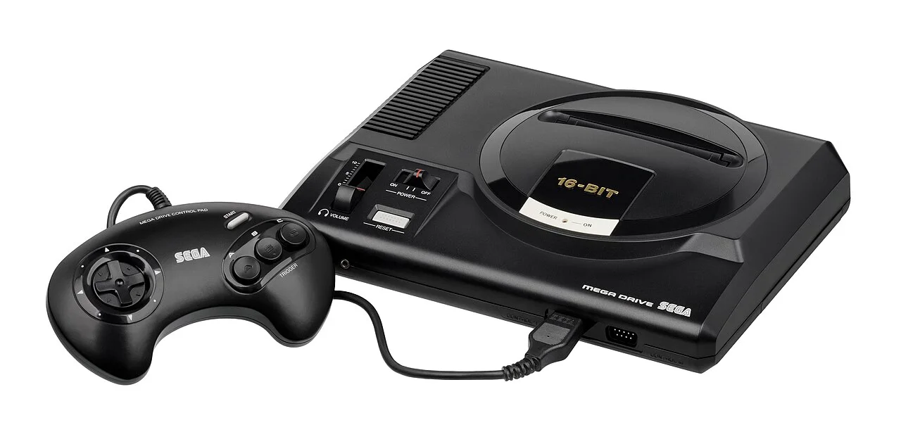 欧版初代 Sega Mega Drive（Mark I）主机与手柄，摄影 Evan-Amos，公有领域，图片来源：Wikimedia Commons。图为欧版初代机型，与日版 Genesis 北美初版在造型细节上略有差异。